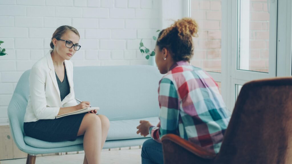 A therapist listens attentively during a private counseling session.